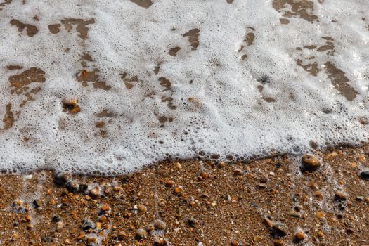 Waves lapping the pebbles on Brighton beach, England, United Kingdom