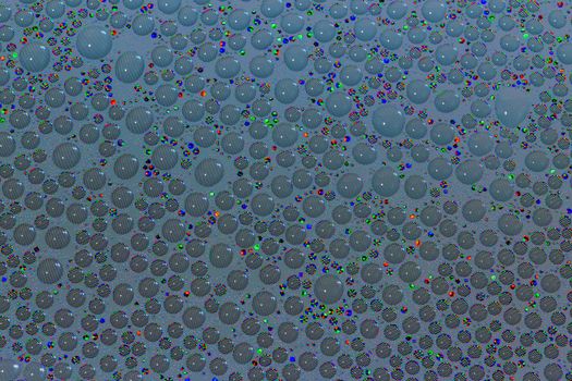 many small water drops on the surface of cellphone hydriphobic coated glass screen, close-up with selective focus and visible subpixel rgb triads