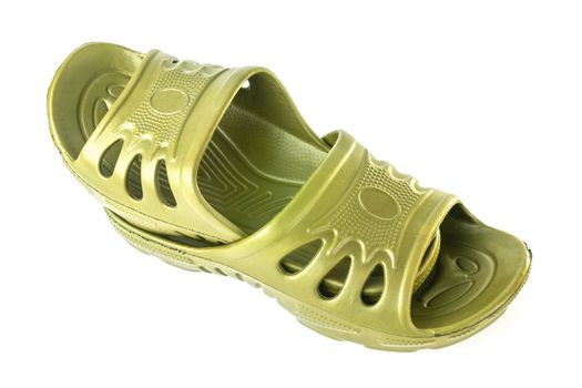 a pair of cheap durable yellow rubber slippers one inside other isolated on white background.