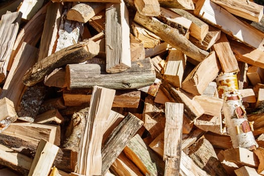 large pile of birch firewood on sunny day outdoor closeup