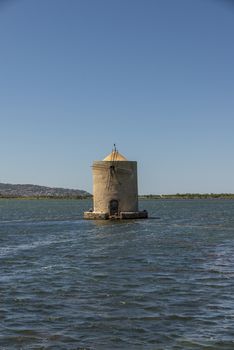 orbetello,italy july 26 2020:old windmill in the middle of the sea in orbetello