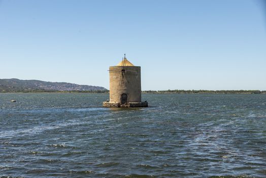 orbetello,italy july 26 2020:old windmill in the middle of the sea in orbetello