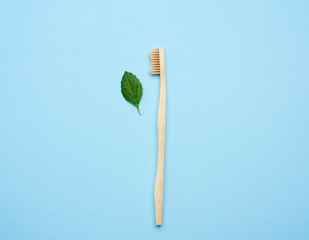 wooden toothbrush on a blue background, plastic rejection concept, zero waste, flat lay 