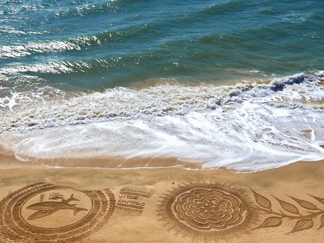 Mandalas drawn in the sand at Praia Maria Luisa in Albufeira in Portugal