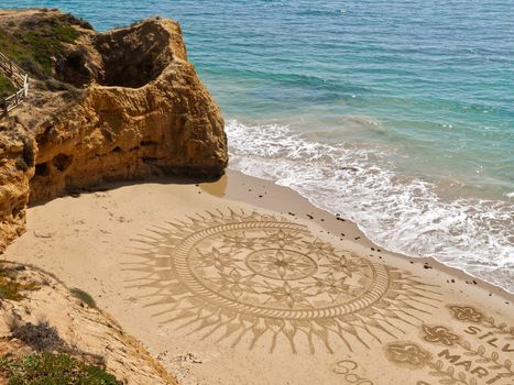 Sand artist Vitor Raposo presents his art at the Algarve beach Praia Maria Luisa in Portugal