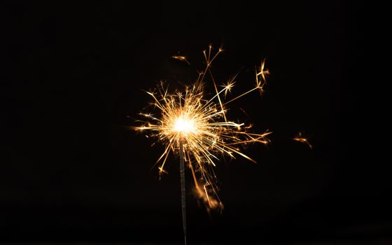 Sparkler background. Christmas and new year sparkler holiday background. bengal light on the black background