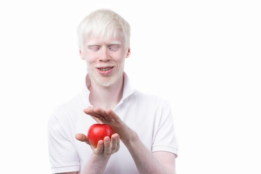 albinism albino man white skin hair studio dressed t-shirt isolated white background. abnormal deviations. unusual appearance. skin abnormality Beautiful people with special appearance. Eat red apple