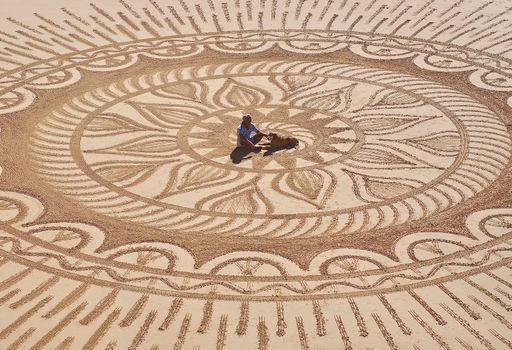 Sand artist Vitor Raposo presents his art at the Algarve beach Praia Maria Luisa in Portugal