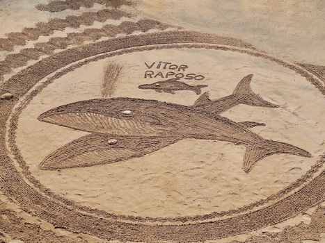 Mandalas drawn in the sand by Vitor Raposo at Praia Maria Luisa in Albufeira in Portugal
