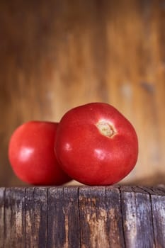 Ripe red tomatoes lie on a wooden frame. High quality photo