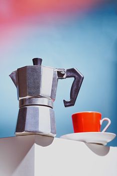 Geyser coffee maker and red cup for coffee shop stand on a white cube. High quality photo