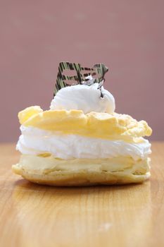 Cream puff cake Dessert on wood background