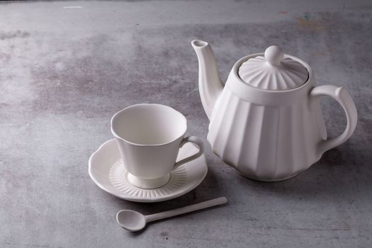 Teapot creamer, Cup and saucer on Cement Board.
