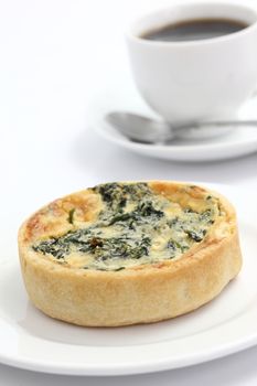 spinach quiche pie with coffee isolated on white background