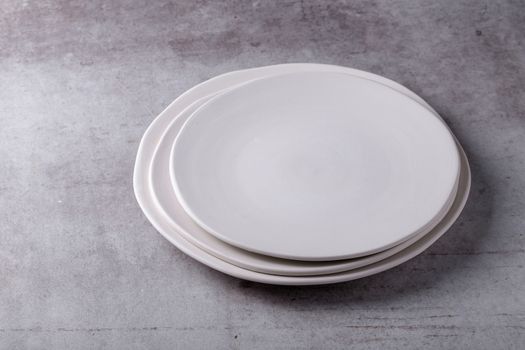 Empty blank white ceramic dish on Cement Board.
