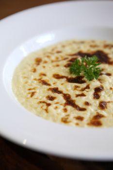 risotto dish with herbs on wood background