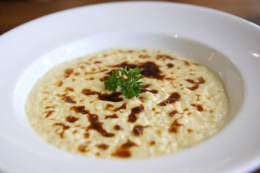 risotto dish with herbs on wood background