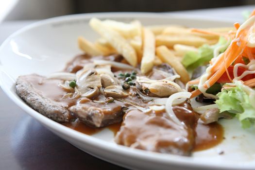 grilled t-bone steak and vegetables 
