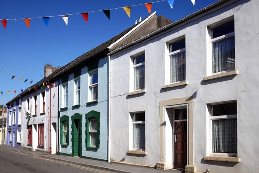 Old fashioned colourful terraced town houses in Kidwelly Carmarthenshire Wales UK stock photo