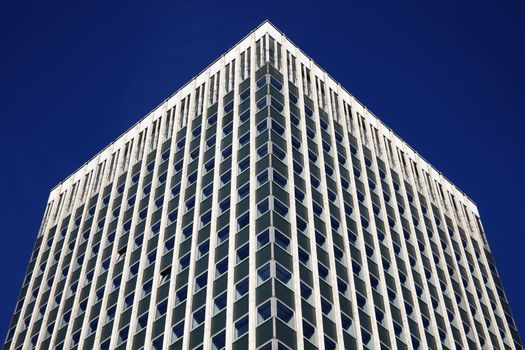 Modern tower block office skyscraper building of  futuristic architecture with a clear blue sky in a downtown financial business district in England UK stock photo