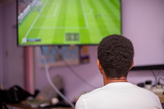 Young boy shot from behind while playing games