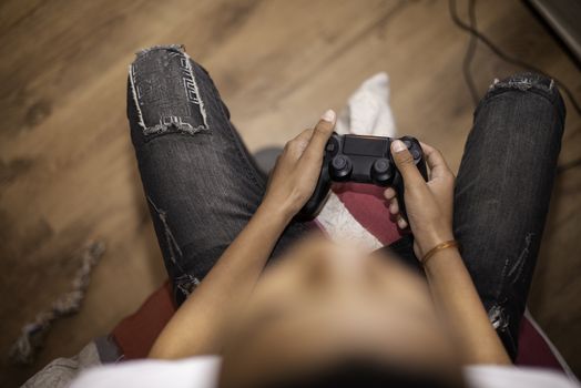 Young boy shot from directly above using game controller