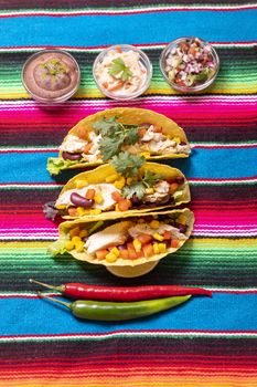 three mexican tacos on cloth