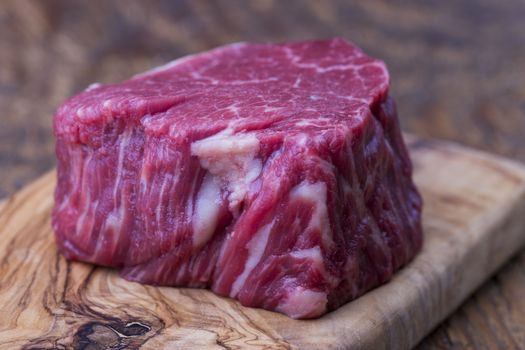 raw steak on dark wood