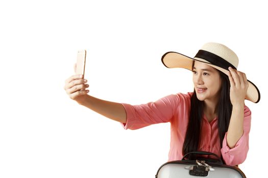 Beautiful asian woman cheerful smiling and take selfie on smart mobile phone, beauty young girl wear hat enjoy and fun in vacation isolated on white background, holiday concept. Asian women long hair wear hat shot photo by yourself with mobile phone.