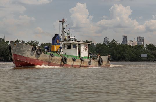 Bangkok, Thailand - 10 Jul 2020 : A cargo ship parked in the middle of the Chao Phraya River with sky at the background.