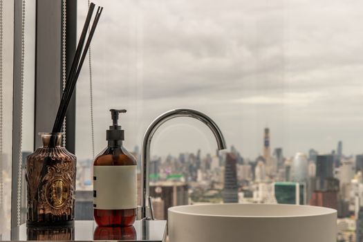 Sky view from rooftop restroom. Interior architecture with cityscape that can look outside from big window. The concept of health care. Selective focus.