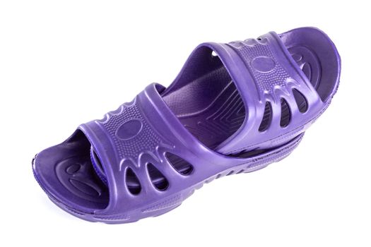 a pair of cheap durable purple rubber slippers one inside other isolated on white background.