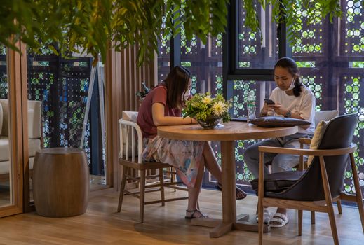 Bangkok, Thailand, Jul 04, 2020 : A meeting of two ladies in co-working space. New normal concept. Selective focus.