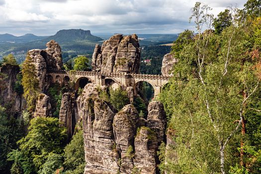 Bastei, view of the Bastei bridge and stone gate. Bastei is famous for the beautiful rock formation in the Saxon Switzerland National Park near Dresden. Popular travel destination in Saxony.