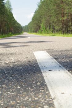 Empty road with forest landscape, concept of target or voyage, Belarus, vertical image