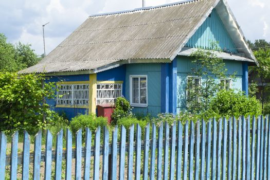 A traditional folk wooden rural house in Belarus with colorful ornamented
