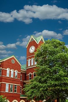 A red brick county courthouse with clock tower