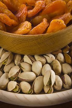 Set of nuts and dried fruits in a wooden bowl