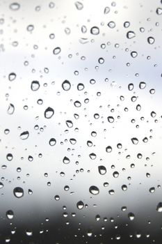 Drops of rain on the window, rainy day. Shallow DOF