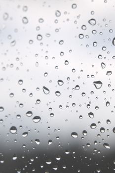 Drops of rain on the window, rainy day. Shallow DOF