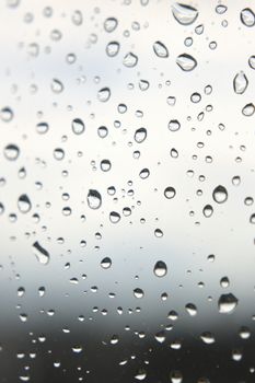 Drops of rain on the window, rainy day. Shallow DOF