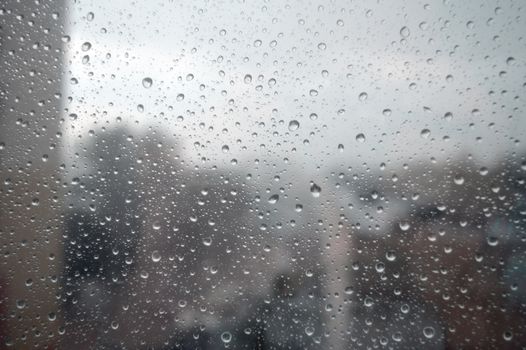 Drops of rain on the window, rainy day. Shallow DOF