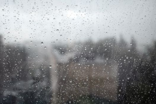 Drops of rain on the window, rainy day. Shallow DOF