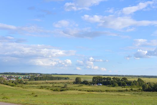 beautiful summer village landscape with sky and clouds