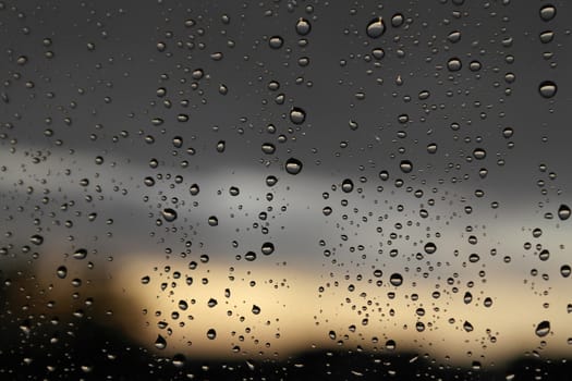 Drops of rain on the window, rainy day. Shallow DOF