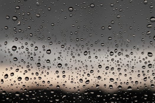 Drops of rain on the window, rainy day. Shallow DOF