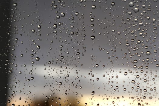 Drops of rain on the window, rainy day. Shallow DOF