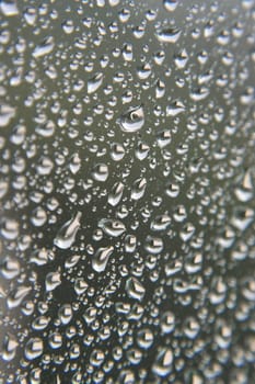 Drops of rain on the window, rainy day. Shallow DOF