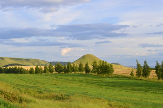 summer landscape with mountain and blue sky with clouds