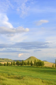 summer landscape with mountain and blue sky with clouds